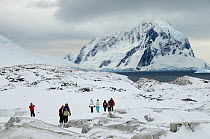 Tourist walking in Petermann Island. Antarctic cruise.