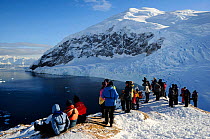 Tourists looking out across Neko Harbour, Andvord Bay. Antarctic Peninsula, Antarctica