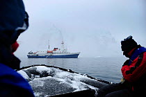 Tourists on zodiac boat with Antarctic cruise liner 'MV Ushuaia' in the background Antarctic Peninsula, Antarctica