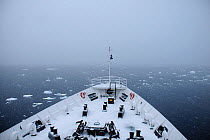 View of Wilhelmina Bay from the snow covered foredeck of an Antarctic cruise liner 'MV Ushuaia' Gerlache Strait. Antarctic Peninsula, Antarctica