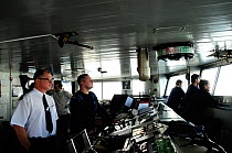 View of control room of Antarctic cruise liner 'MV Ushuaia' with captain and crew looking out of the window, Antarctica