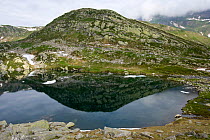 Hill reflecting in the Lake Sassolo, Sambuco valley, Ticino, Switzerland