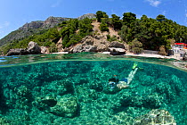 Woman snorkeling in front of the beach of Komiza, Vis Island, Croatia, Adriatic Sea, Mediterranean