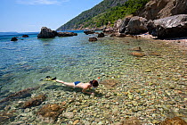 Woman snorkeling in front of the beach of Komiza, Vis Island, Croatia, Adriatic Sea, Mediterranean