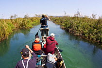 Group in small paddle boat in search of anaconda, with photography equipment, Formoso River, Bonito, Mato Grosso do Sul, Brazil