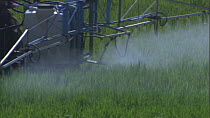 Close-up of a tractor spraying pesticide or fertiliser on a field, France, April.