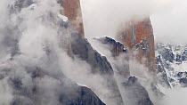 Trango towers in fog, the world's tallest cliffs, Baltoro Glacier, Baltistan, part of the Gilgit-Baltistan territory, northern Pakistan. July 2007.