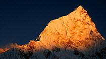 The last light of day illuminates the summit of Nuptse (7861m). Khumbu, Nepal. October 2011