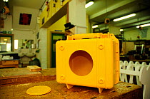Hole cut into box to create remote camera casing 'Bear box' used by Bertie Gregory for photographing bears and wolves, England, June 2011.
