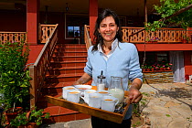 Bed and breakfast hotel owner Betty, with cups of tea, Wild Farm in Madzharovo valley, Eastern Rhodope Mountains, Bulgaria, May 2013.