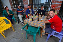 Men drinking outside bar in Plevun, Eastern Rhodope Mountains, Bulgaria, May 2013.