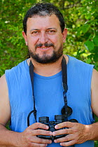 Ranger and field officer Todor Mitkov with binoculars, Plevun, Eastern Rhodope Mountains, Bulgaria, May 2013.