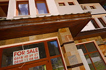 For sale signs in house window, Pamporovo, Western Rhodope Mountains, Bulgaria, May 2013.