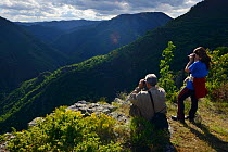 Tourists watching wildlife, Deven area, Western Rhodope Mountains, Bulgaria, May 2013.
