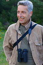 Vlado Peikov, hunting area manager, with binoculars, Deven area, Western Rhodope Mountains, Bulgaria, May 2013.