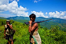 Two Naga men hunting with rifles, Arunachal Pradesh, India, 2009.