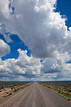 Blue sky with clouds above road in Heart Mountain National Antelope Refuge, Oregon, USA, May 2013.