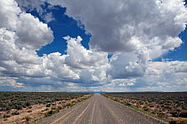 Blue sky with clouds above road in Heart Mountain National Antelope Refuge, Oregon, USA, May 2013.