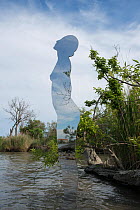 Giant mirror in the shape of a woman emerging from river, a public sculpture by Rob Mullholland, Port Saint Louis du Rhone, Camargue, France, May 2013. Editorial Use only. Credit Jean Roche / Le Citro...