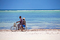 Two Zanzibari men on a bicycle, Matemwe, Zanzibar, Tanzania