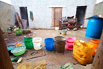 Buckets laid out in a courtyard to collect rainwater, Tanzania, Africa