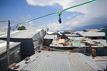 Basic electric wiring linking homes in a slum with a diesel powered generator, Remba Island, Lake Victoria, Kenya.