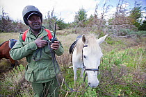 Wildlife poaching patrol unit on horseback give radio update, Mount Kenya National Park, Kenya