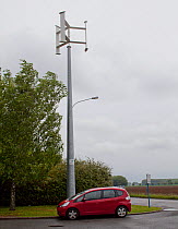 Vertical axis wind turbine charging an electric car, France, May 2013.