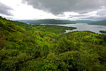 Landscape of Koyna Lake, with houses, during the monsoon. Western Ghats, India.