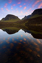 The Quiraing reflected in Loch at sunset, Isle of Skye, Scotland, April 2011.