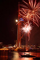 Fireworks display and full Moon over Spinnaker Tower, Gunwharf Quay, Portsmouth, Hampshire, England, UK. November 2012.