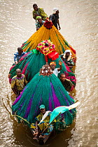 Aerial view of 'Zangbeto' guardians of the night, and priests in boat going to visit another village for voodoo / vodun ceremony, Benin, Africa, February 2011.