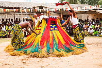 Men with 'Zangbeto' a traditional guardian of the night, at voodoo / vodun ceremony, Benin, Africa, February 2011.