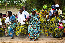 Men and women dancing during Zangbeto voodoo ceremony. Benin, Africa, February 2011.