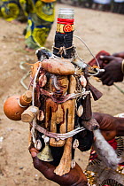 Several 'fetishes' attached to a glass bottle, at a voodoo / vodun ceremony, Benin, Africa. February 2011.