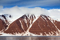 Landscape view of red cliffs of the Bockjorden, Woodfjord, Spitzbergen, Svalbard, Norway, June 2012.