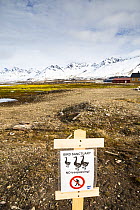 Sign warning of ground nesting birds, Ny-Alesund International Research Village, Spitzbergen, Svalbard, Norway, June, 2012.