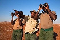 Save the Rhino Trust trackers (l-r) Denso Tjiraso, Martin Nawaseb, Epson Rukuma at Desert Rhino Camp, Wilderness Safaris, Kunene region, Namibia, May 2013