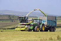 Forage harvester cutting grass for silage on the Clun Hills, south Shropshire, UK, July 2013.
