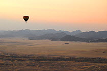 Hot air balloon ride over the Namib desert at sunset, Namibia, February 2005.