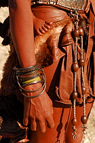 Ornaments worn by Himba woman, carrying child on back, Kaokoland, Namibia, June 2006.