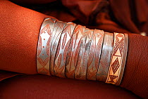 Bracelets on the arm of a Himba woman, Kaokoland, Namibia.