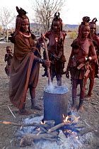 Himba women cooking at dawn. Kaokoland, Namibia, September 2013.