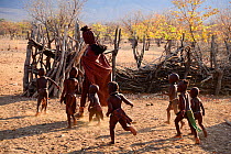 Himba woman with group of children outside the village. Kaokoland, Namibia, September 2013.