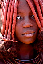 Portrait of Himba woman with characteristic Otjize (a mix of butter ash and ochre) covering hair and skin, Kaokoland, Namibia, September 2013.