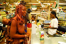 Himba woman in supermarket with baby, Opuwo, Namibia, February 2005.