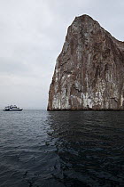 View of Kicker Rock with boat in backdrop, San Cristobal Island, Galapagos Islands, January 2012.