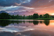 Lake with clouds reflected with High Tatras Mountains at dawn, Tatranska Strba, Slovakia, June 2013.