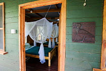 Budongo Eco Lodge cabin, showing mosquito nests over the the beds, Budongo Forest Reserve, Uganda.