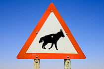 Traffic sign warning of Brown Hyaena (Hyaena brunnea) crossing,  Luderitz, Namib desert, Namibia.